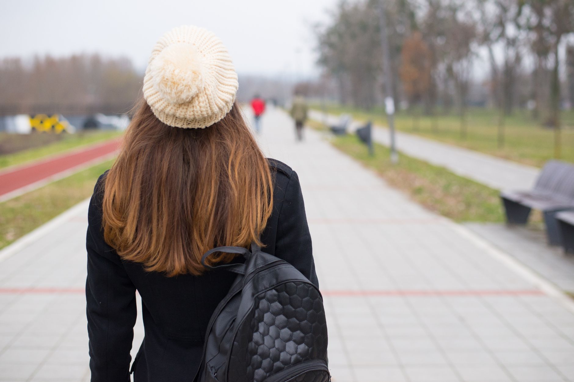 Person walking outdoors after stress to regulate emotions in recovery