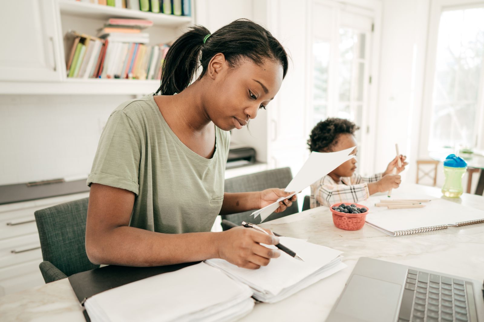 Calm patient preparing documents at home for a telehealth medical appointment
