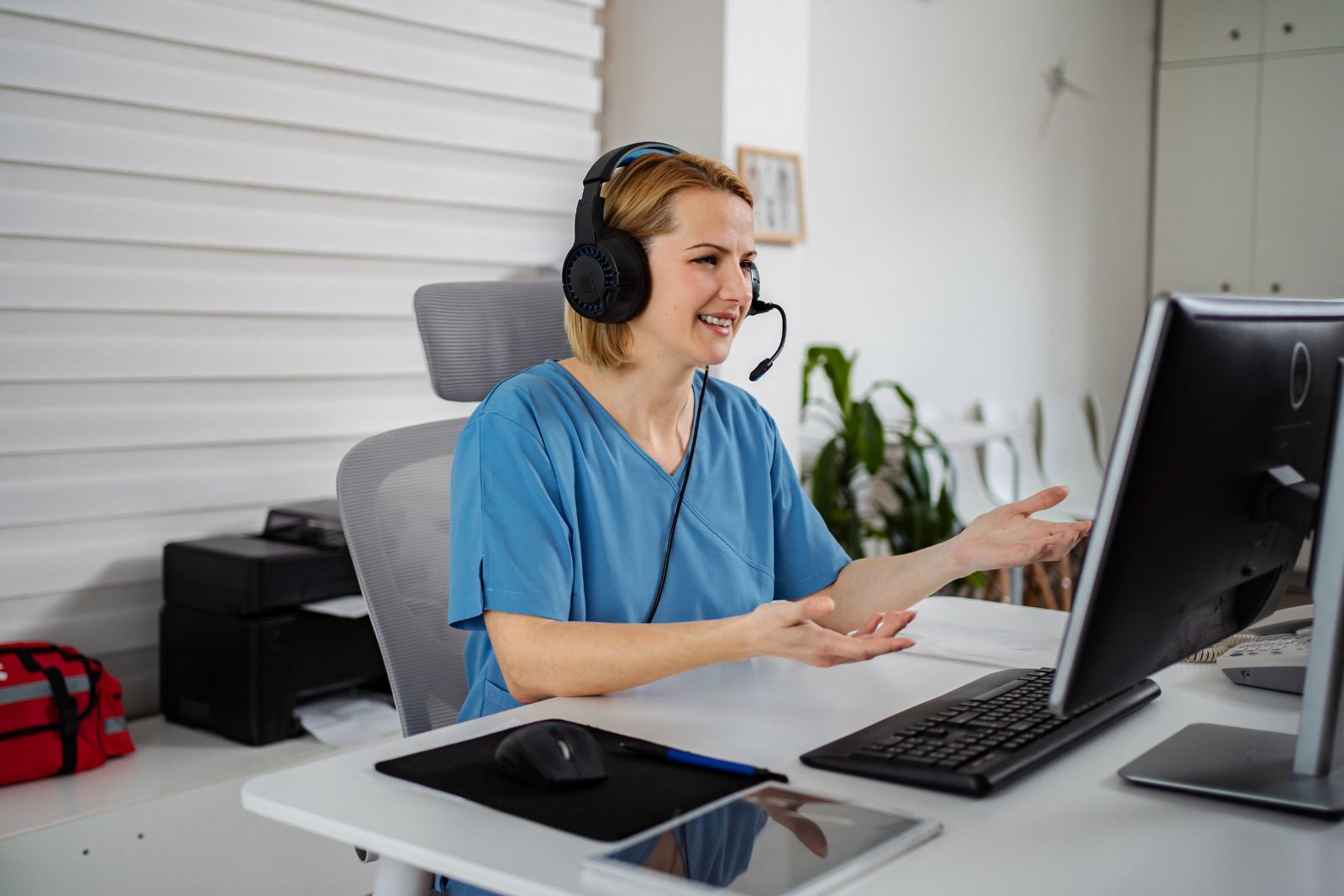 Telehealth reschedule support with laptop and phone on a desk