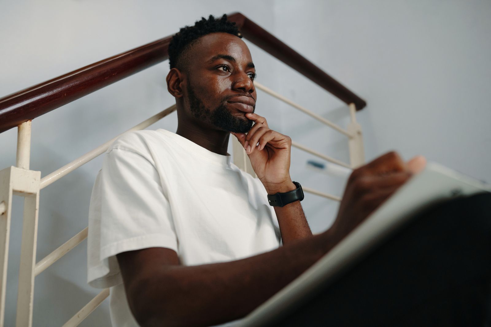 Thoughtful man sitting alone reflecting in a calm indoor setting