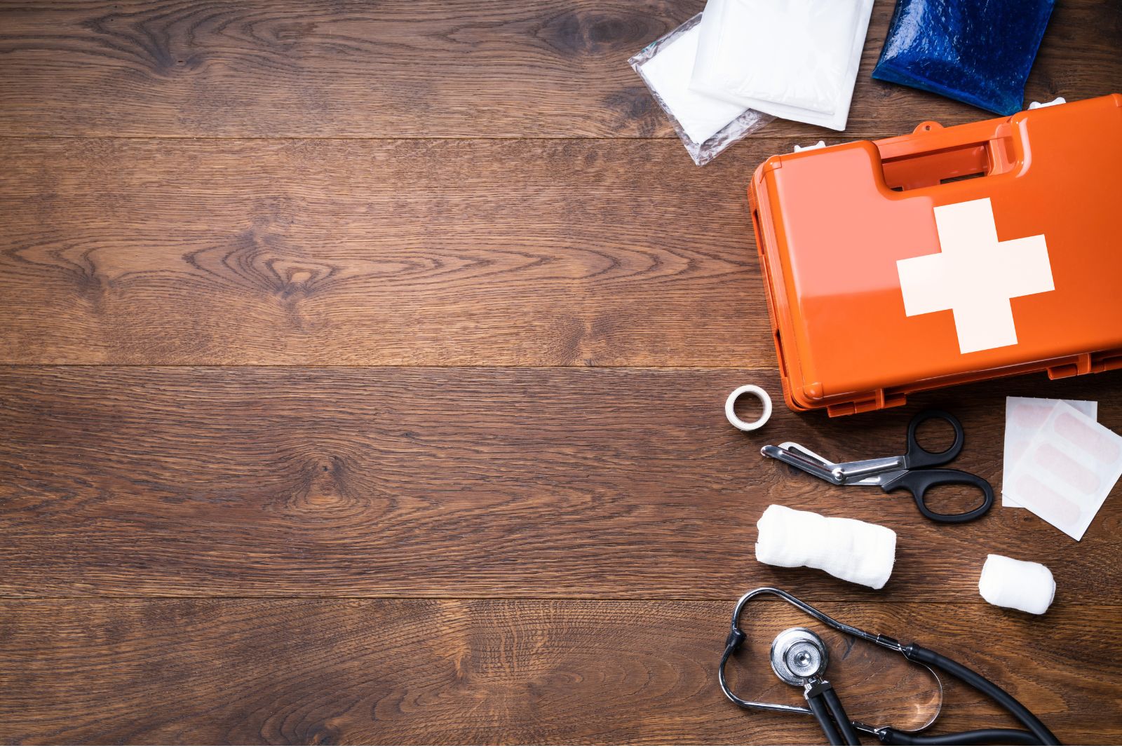 Adult holding a phone beside a first-aid kit