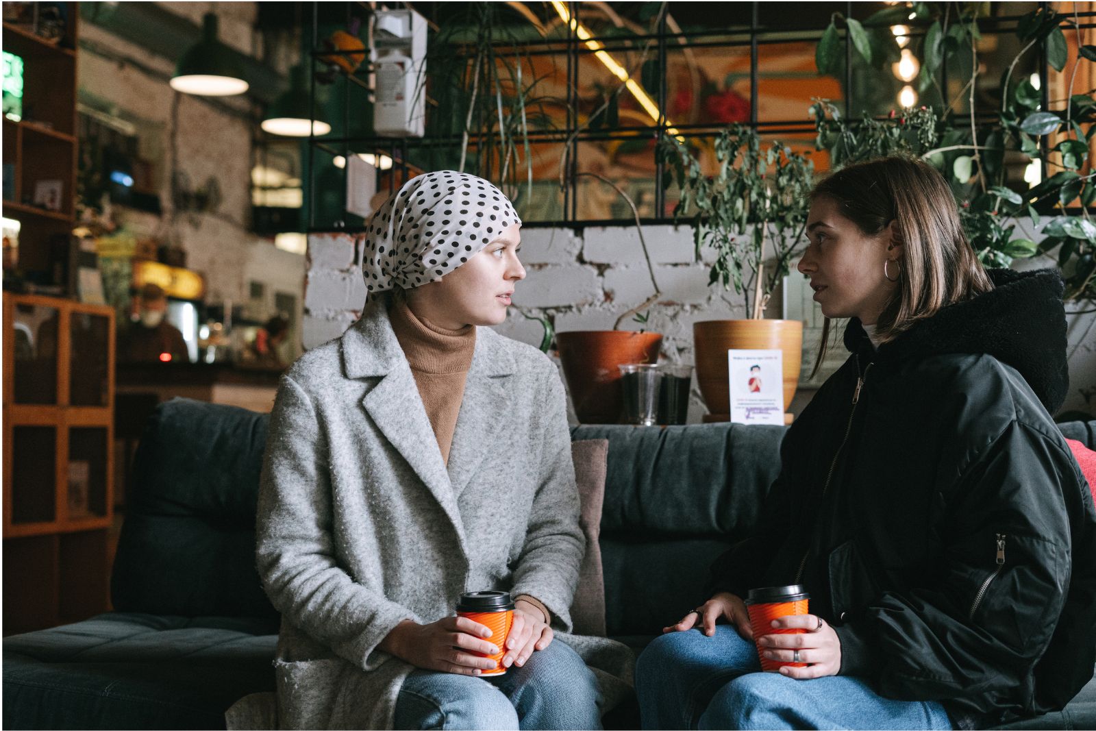 Two adults talking together in a community lounge